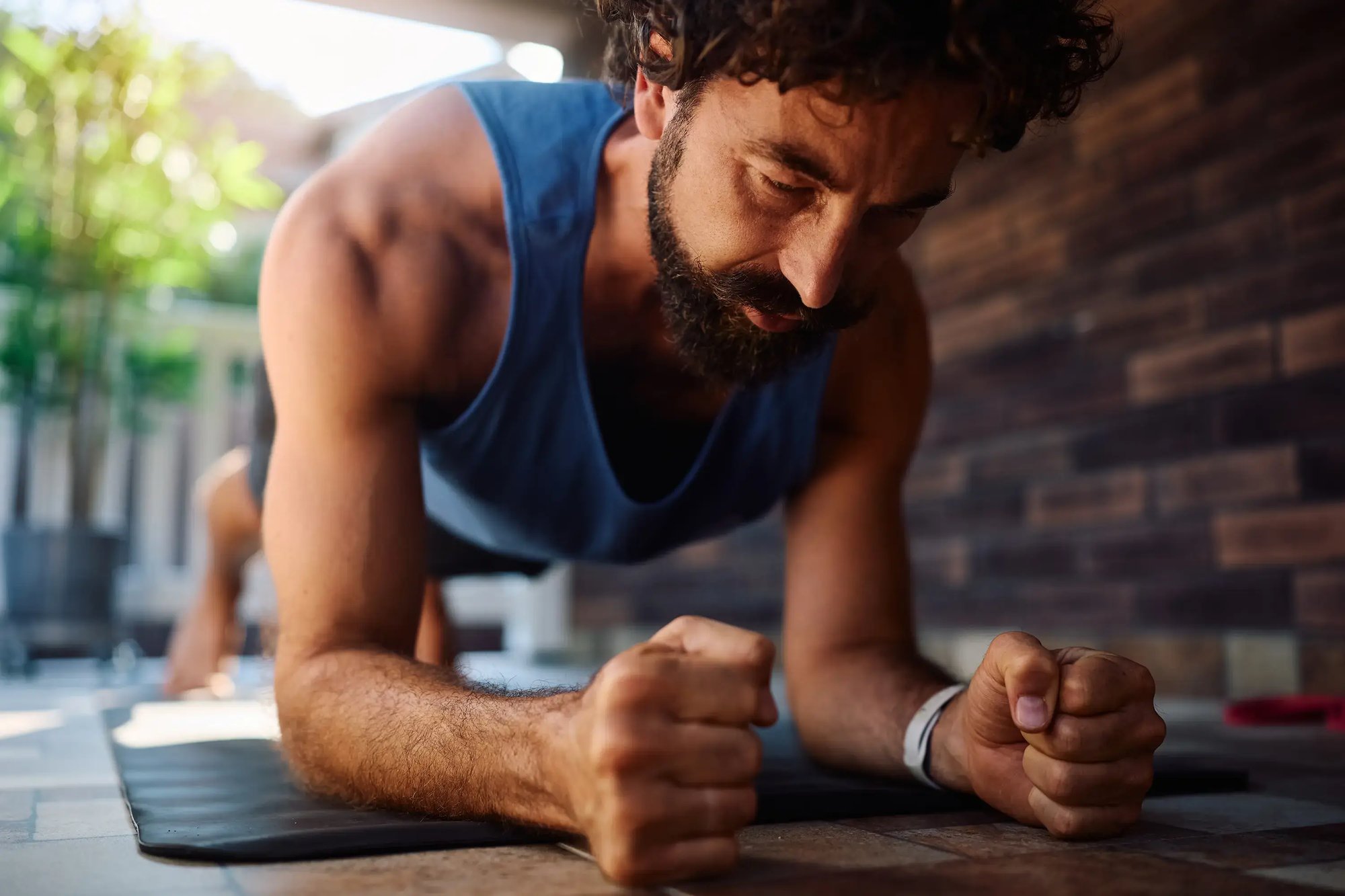 men-health_peptides_athletic-man-plank-exercise